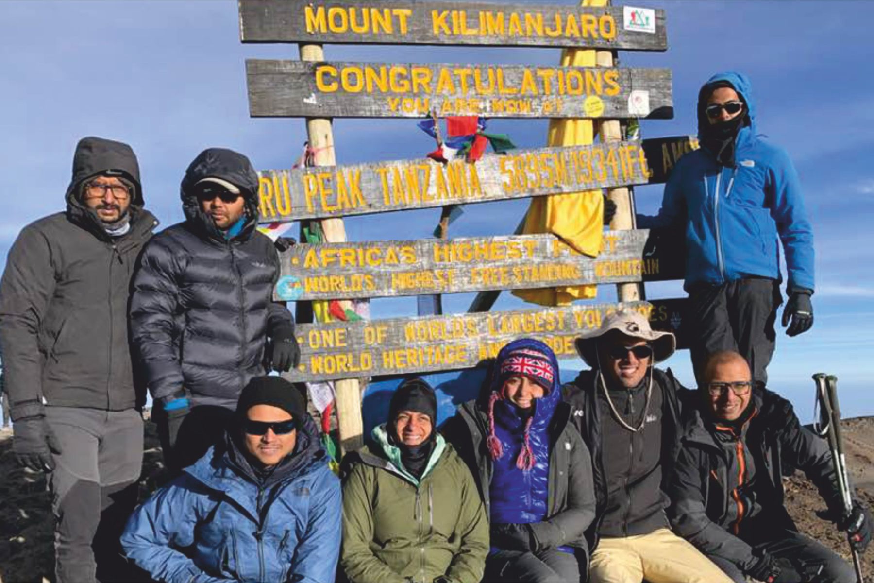 The QDE team at the Uhuru Peak summit sign on Mount Kilimanjaro