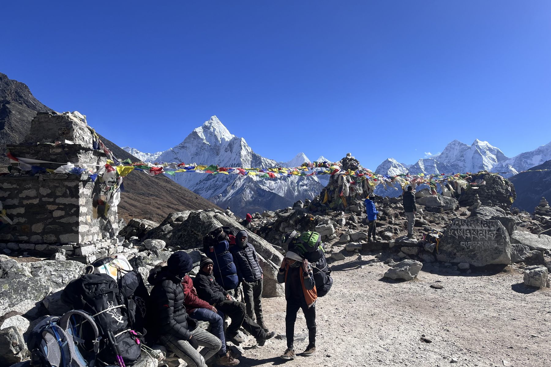 Prayer flags and the Ama Dablam peak on the Everest Base Camp trail