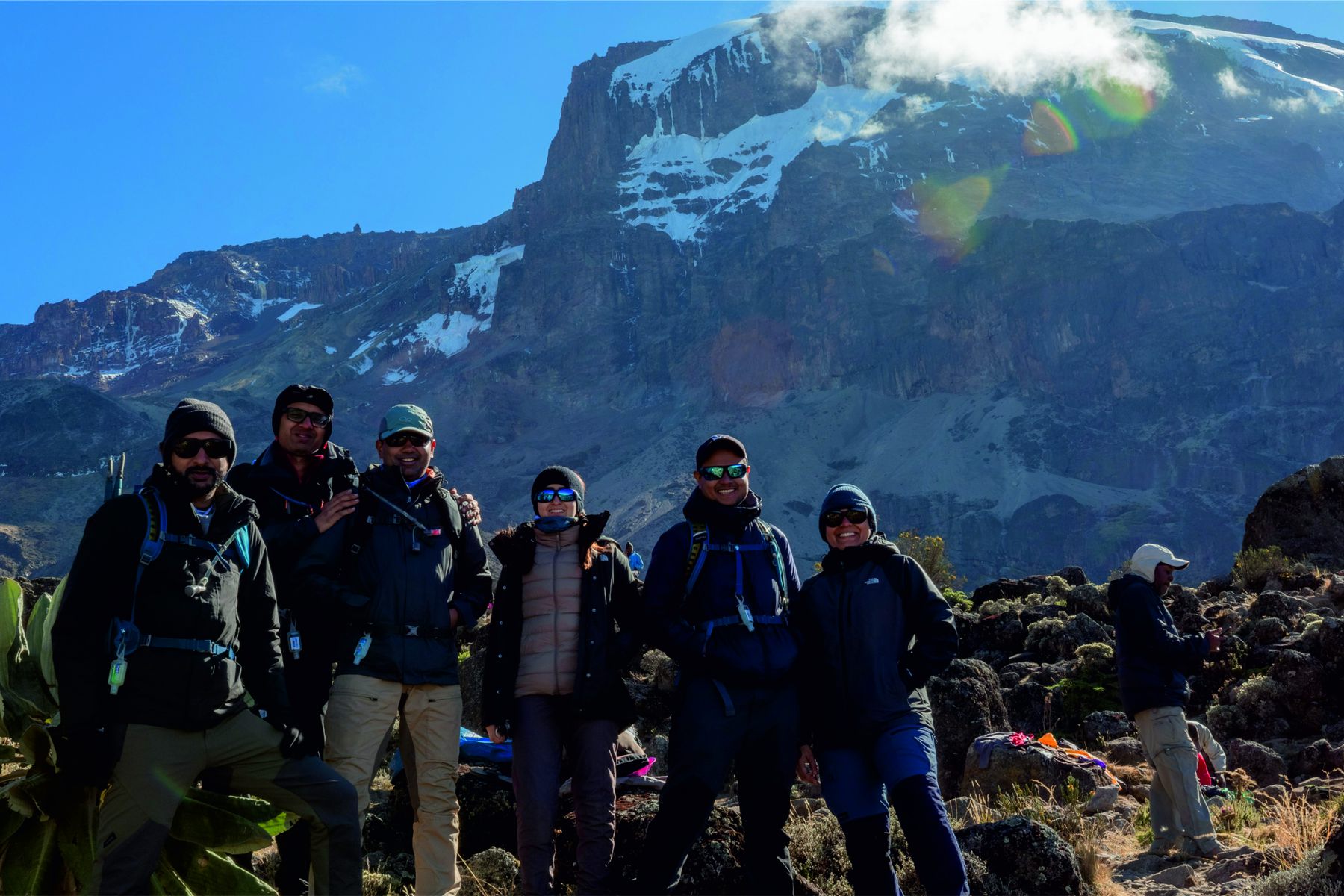 The QDE team below the snow-capped summit of Mount Kilimanjaro